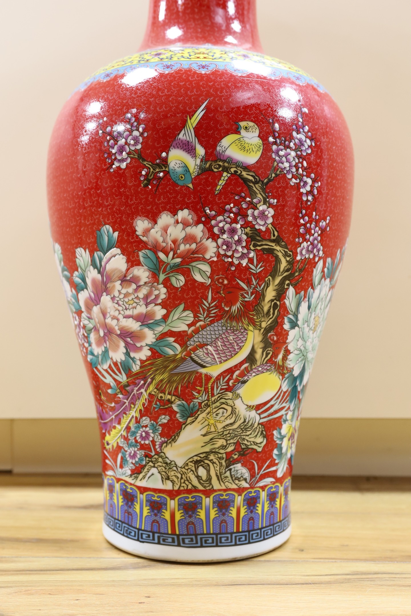 A large modern red ground Chinese vase with floral decoration - 68.5cm tall